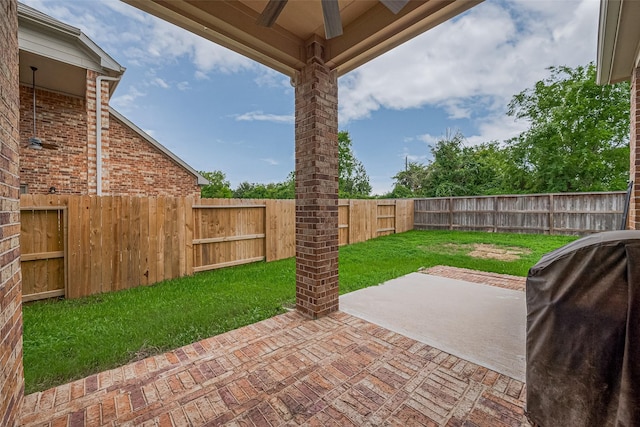 16747 Highland Country Dr, Cypress, TX 77433 - fenced backyard with a patio area, ceiling fan, and grilling area