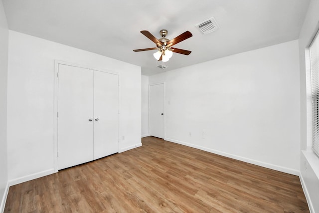 5818 Taylan Ln, Rosenberg, TX 77471 - unfurnished bedroom with wood finished floors, baseboards, a closet, and ceiling fan