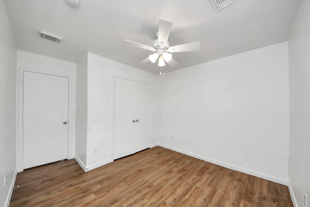 5818 Taylan Ln, Rosenberg, TX 77471 - unfurnished bedroom with wood finished floors, baseboards, a closet, and ceiling fan