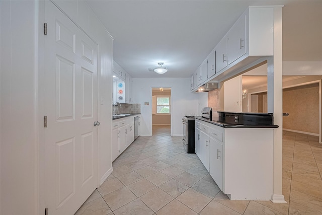 9647 Winsome Ln, Houston, TX 77063 - kitchen featuring appliances with stainless steel finishes, a sink, light tile patterned floors, and under cabinet range hood