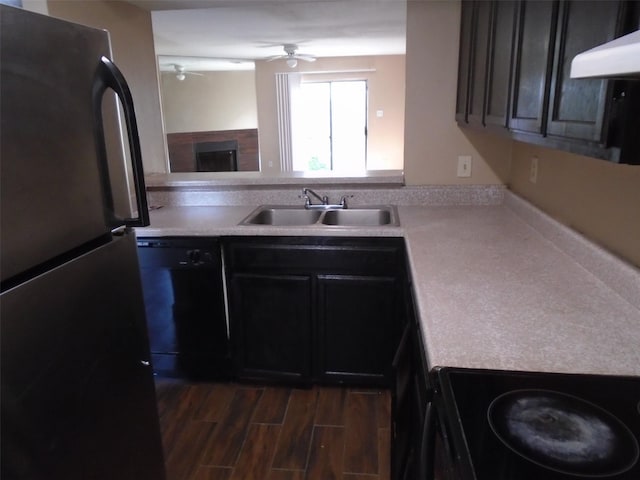 12651 Windsor Village Dr, Houston, TX 77071 - kitchen featuring black appliances, a sink, a ceiling fan, under cabinet range hood, and light countertops