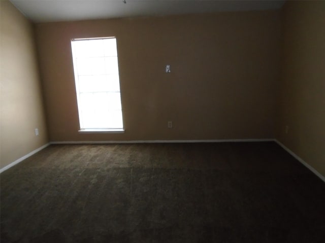 12651 Windsor Village Dr, Houston, TX 77071 - empty room with plenty of natural light, dark carpet, and baseboards