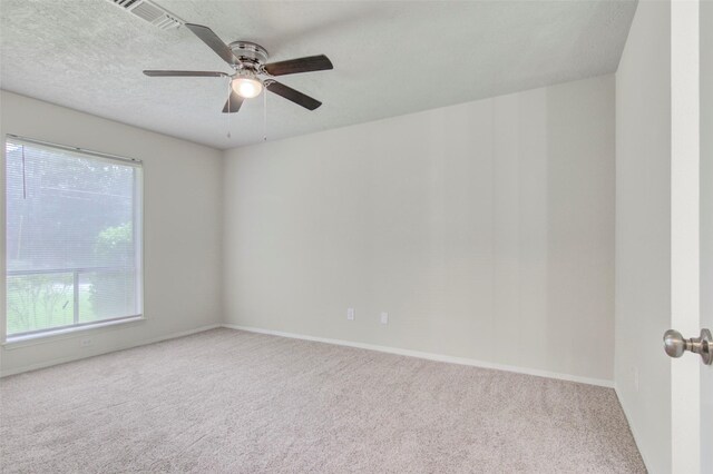206 Verna St, Jasper, TX 75951 - spare room featuring carpet, ceiling fan, baseboards, and a textured ceiling