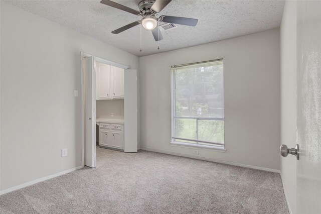 206 Verna St, Jasper, TX 75951 - spare room with light carpet, baseboards, a textured ceiling, and ceiling fan