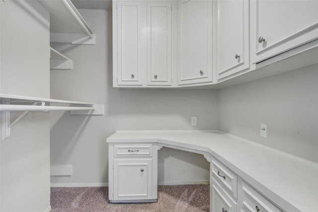 206 Verna St, Jasper, TX 75951 - unfurnished office featuring built in desk, carpet, and baseboards