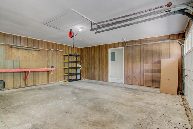 206 Verna St, Jasper, TX 75951 - garage with wood walls, electric panel, and a workshop area
