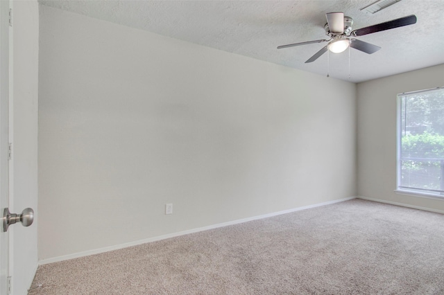 206 Verna St, Jasper, TX 75951 - unfurnished room with carpet flooring, ceiling fan, baseboards, and a textured ceiling