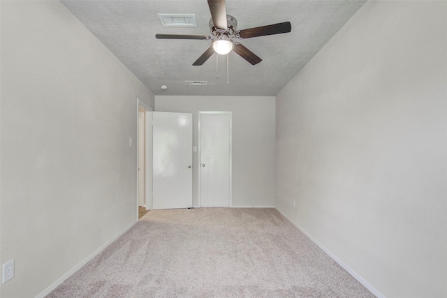 206 Verna St, Jasper, TX 75951 - unfurnished bedroom featuring light colored carpet, a textured ceiling, baseboards, and a ceiling fan