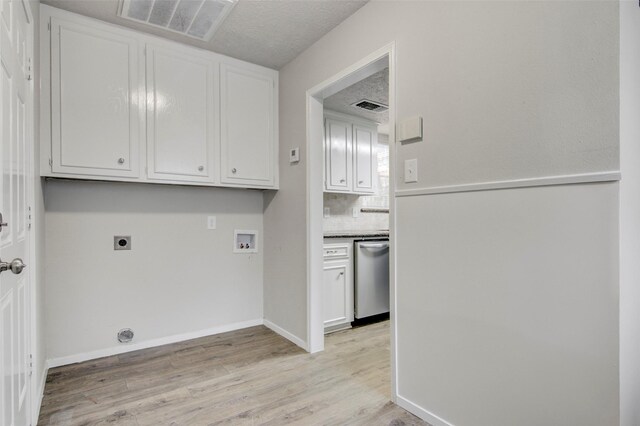 206 Verna St, Jasper, TX 75951 - laundry room featuring electric dryer hookup, hookup for a washing machine, light wood-style floors, and cabinet space