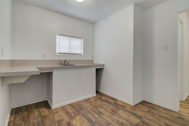 206 Verna St, Jasper, TX 75951 - kitchen with a sink, wood finished floors, light countertops, baseboards, and a peninsula