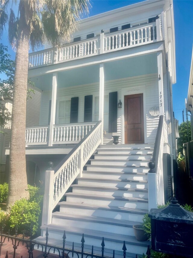 1717 Winnie St, Galveston, TX 77550 - view of front of house with a balcony, covered porch, and stairway