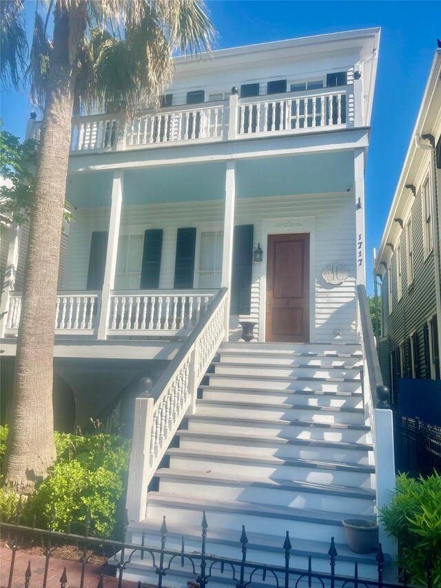 1717 Winnie St, Galveston, TX 77550 - view of front of home with a balcony, stairway, and covered porch