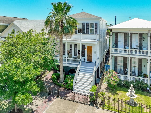 1717 Winnie St, Galveston, TX 77550 - view of front facade with a porch, stairs, and a gate