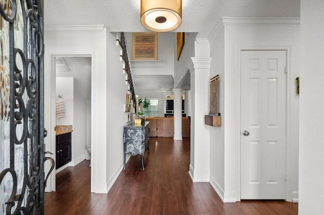 15106 Cranbourne Dr, Houston, TX 77062 - foyer entrance featuring ornate columns, dark wood-type flooring, baseboards, and ornamental molding