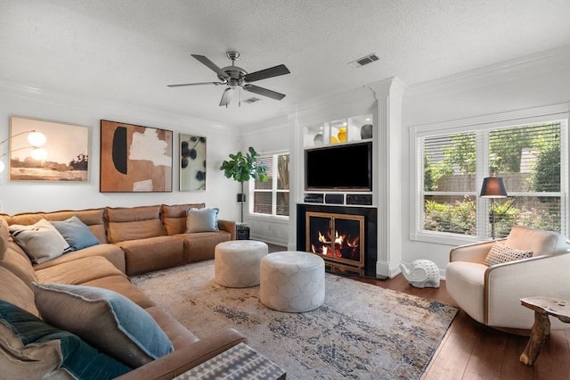 15106 Cranbourne Dr, Houston, TX 77062 - living area featuring a lit fireplace, wood finished floors, ornamental molding, and ceiling fan