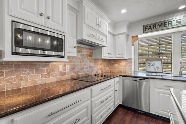 15106 Cranbourne Dr, Houston, TX 77062 - kitchen with appliances with stainless steel finishes, a sink, white cabinetry, dark stone counters, and dark wood finished floors