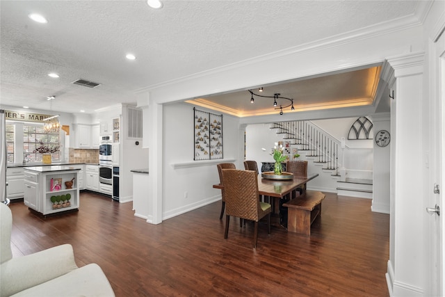 15106 Cranbourne Dr, Houston, TX 77062 - dining room with stairway, dark wood-style flooring, a textured ceiling, crown molding, and recessed lighting