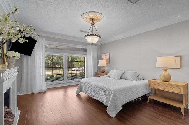 15106 Cranbourne Dr, Houston, TX 77062 - bedroom featuring crown molding, a textured ceiling, wood finished floors, and a fireplace