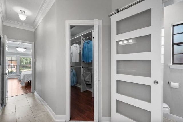 15106 Cranbourne Dr, Houston, TX 77062 - hall featuring crown molding, built in features, baseboards, and a barn door