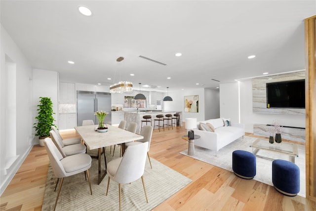 dining room featuring light wood-type flooring and recessed lighting