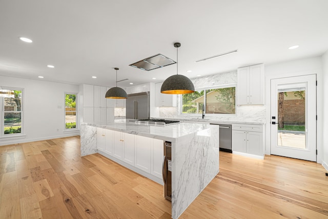 kitchen with dishwasher, white cabinets, a sink, light wood-style floors, and recessed lighting