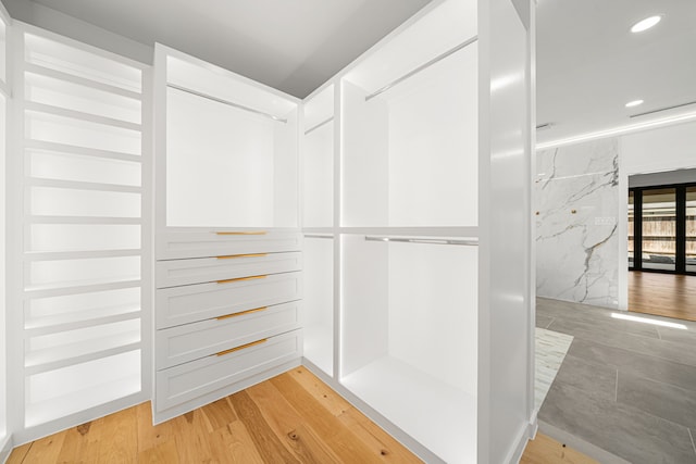 spacious closet featuring light wood-type flooring