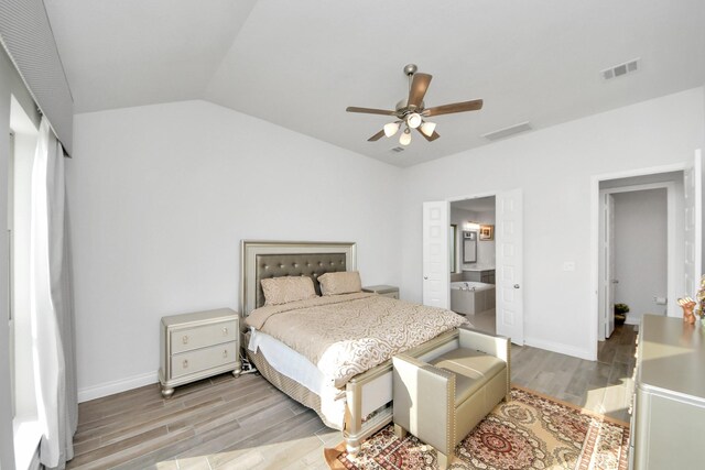 1935 Creekwood Cv, Missouri City, TX 77459 - bedroom with wood finished floors, baseboards, vaulted ceiling, ensuite bath, and a ceiling fan