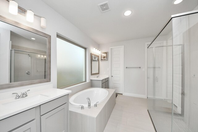 1935 Creekwood Cv, Missouri City, TX 77459 - full bath featuring a stall shower, a garden tub, recessed lighting, two vanities, and tile patterned flooring