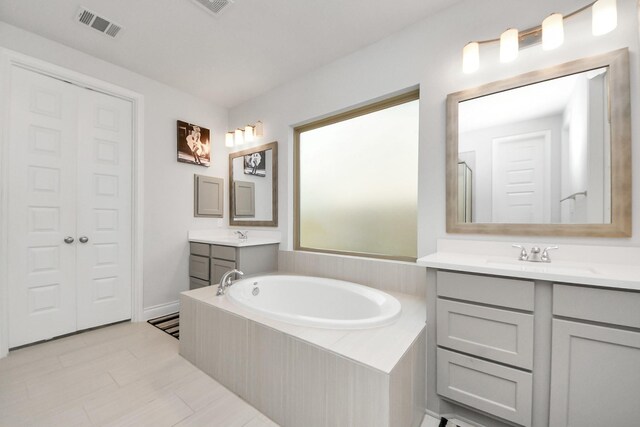 1935 Creekwood Cv, Missouri City, TX 77459 - bathroom with a garden tub and two vanities