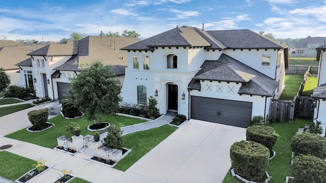 1935 Creekwood Cv, Missouri City, TX 77459 - french country home featuring stucco siding, concrete driveway, an attached garage, a residential view, and a shingled roof