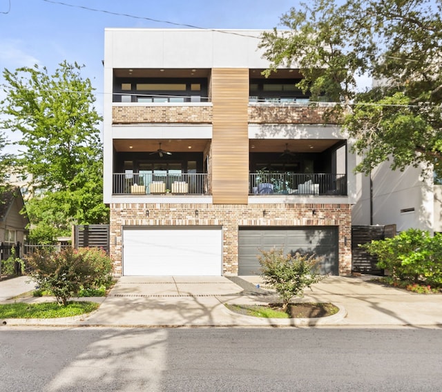 2621 Greenbriar Dr, Houston, TX 77098 - view of front of home with a garage, concrete driveway, brick siding, and a balcony
