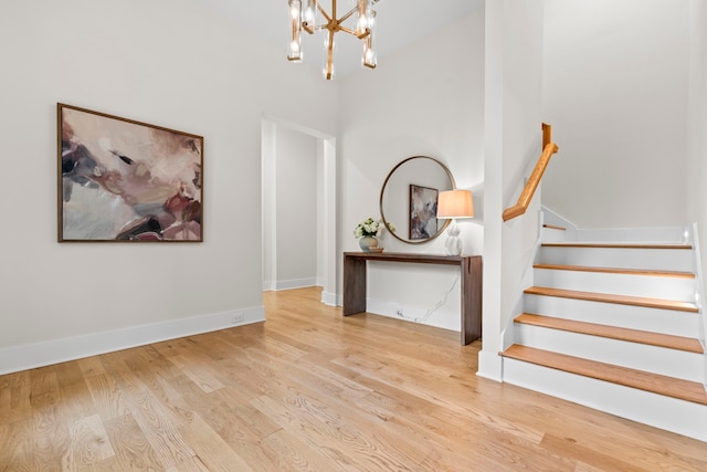 2621 Greenbriar Dr, Houston, TX 77098 - stairs featuring wood finished floors, a chandelier, baseboards, and a towering ceiling