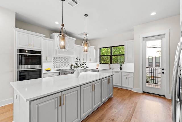 2621 Greenbriar Dr, Houston, TX 77098 - kitchen featuring stainless steel appliances, a sink, white cabinetry, tasteful backsplash, and recessed lighting
