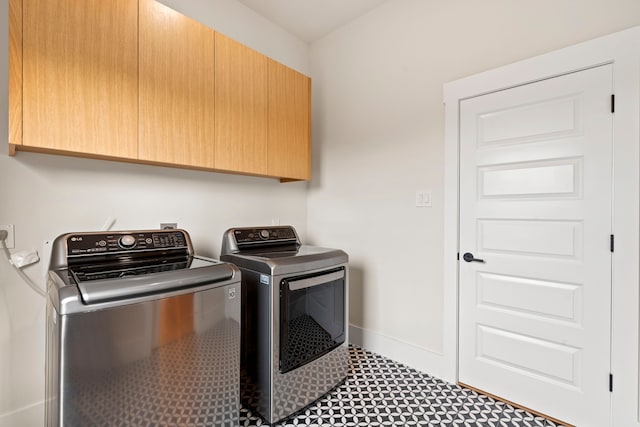 2621 Greenbriar Dr, Houston, TX 77098 - laundry room featuring cabinet space, independent washer and dryer, tile patterned floors, and baseboards