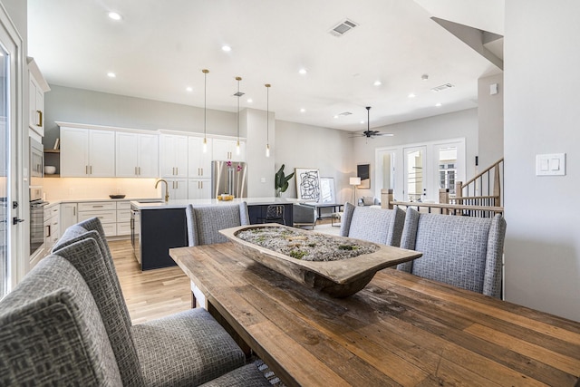 2216 Francis St, Houston, TX 77004 - dining area with light wood-style flooring, recessed lighting, ceiling fan, and stairway