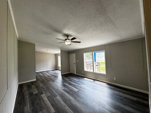18549 Indigo Way, Porter, TX 77365 - spare room featuring dark wood-type flooring, a textured ceiling, a ceiling fan, ornamental molding, and baseboards