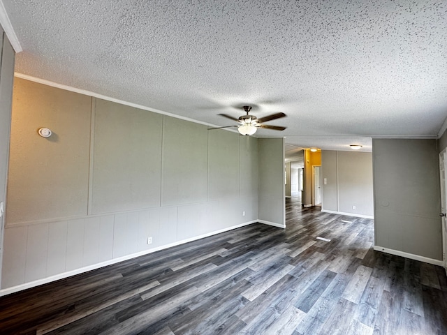 18549 Indigo Way, Porter, TX 77365 - empty room with dark wood-style flooring, ceiling fan, a textured ceiling, crown molding, and a decorative wall