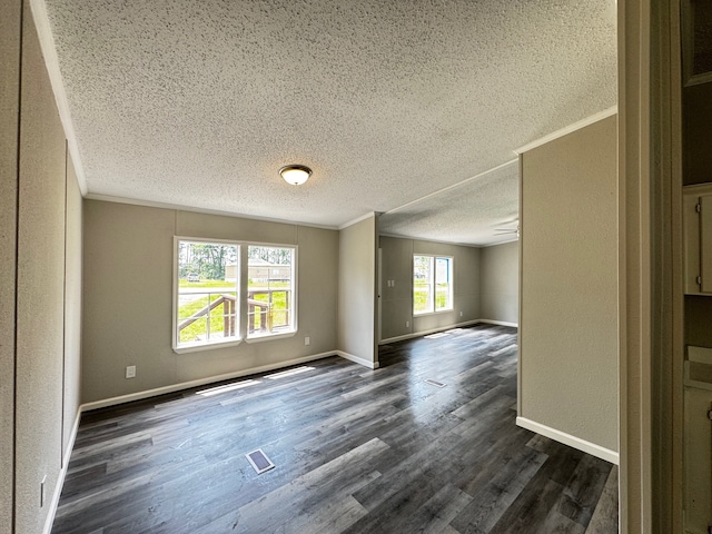 18549 Indigo Way, Porter, TX 77365 - unfurnished room with a textured ceiling, ornamental molding, dark wood-style flooring, baseboards, and a textured wall
