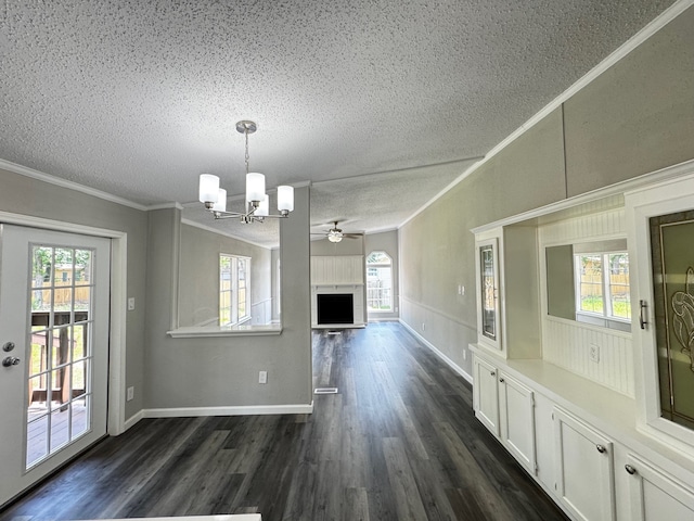 18549 Indigo Way, Porter, TX 77365 - unfurnished dining area with a textured ceiling, a chandelier, crown molding, dark wood-style flooring, and ceiling fan