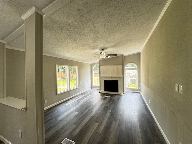 18549 Indigo Way, Porter, TX 77365 - unfurnished living room featuring ceiling fan, a textured ceiling, dark wood finished floors, lofted ceiling, and a fireplace with raised hearth