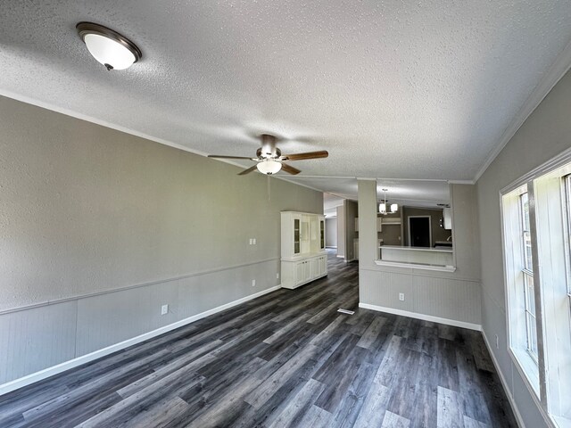 18549 Indigo Way, Porter, TX 77365 - unfurnished living room featuring dark wood-type flooring, a textured ceiling, ceiling fan, a chandelier, and wainscoting