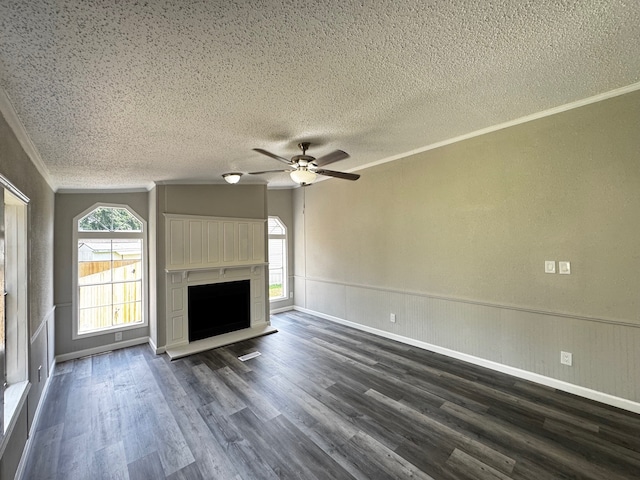 18549 Indigo Way, Porter, TX 77365 - unfurnished living room with dark wood-type flooring, ceiling fan, ornamental molding, a textured ceiling, and wainscoting