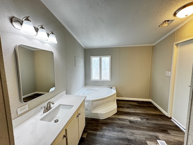 18549 Indigo Way, Porter, TX 77365 - bathroom featuring a textured ceiling, ornamental molding, a bath, vanity, and wood finished floors