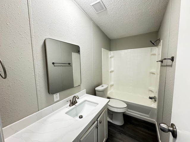 18549 Indigo Way, Porter, TX 77365 - full bath featuring a textured ceiling, wood finished floors, toilet, vanity, and shower / washtub combination