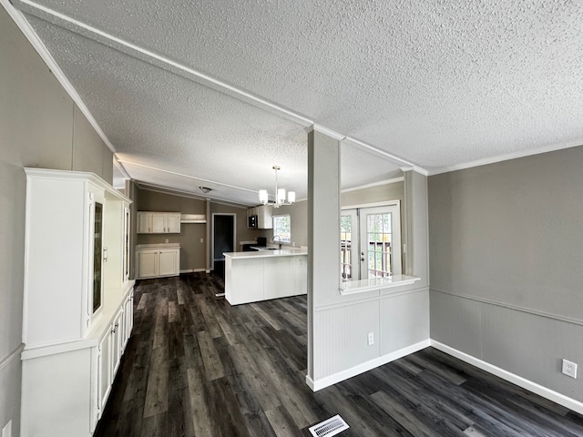 18549 Indigo Way, Porter, TX 77365 - kitchen featuring a chandelier, dark wood-style floors, ornamental molding, lofted ceiling, and a textured ceiling