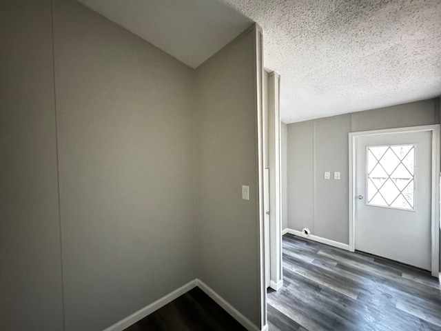 18549 Indigo Way, Porter, TX 77365 - foyer entrance featuring a textured ceiling, dark wood-type flooring, and baseboards