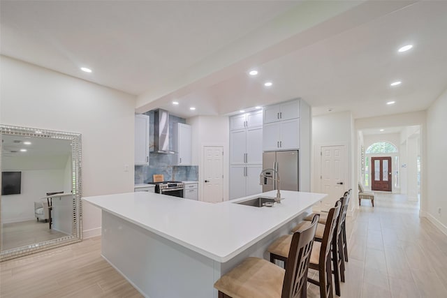 11316 Misty Morning St, Pearland, TX 77584 - kitchen with wall chimney range hood, stainless steel appliances, recessed lighting, decorative backsplash, and light countertops