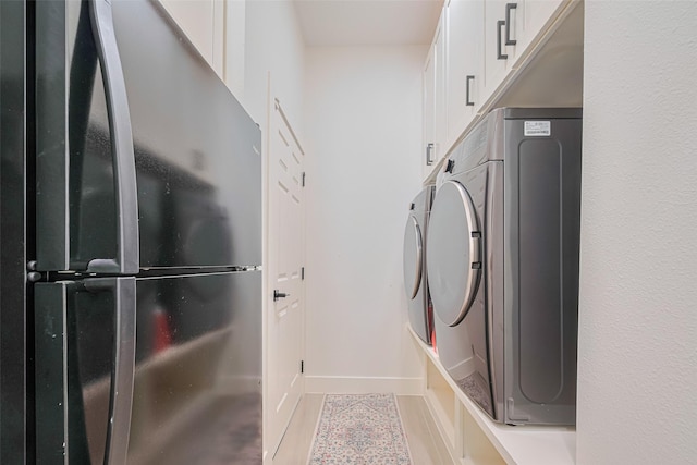 11316 Misty Morning St, Pearland, TX 77584 - washroom featuring independent washer and dryer, cabinet space, baseboards, and light tile patterned floors