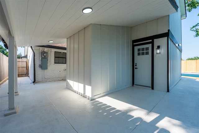 2514 Haverhill Dr, Houston, TX 77008 - doorway to property featuring fence, a patio, brick siding, and board and batten siding