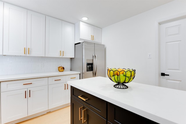 2514 Haverhill Dr, Houston, TX 77008 - kitchen featuring stainless steel fridge with ice dispenser, light countertops, white cabinets, backsplash, and recessed lighting